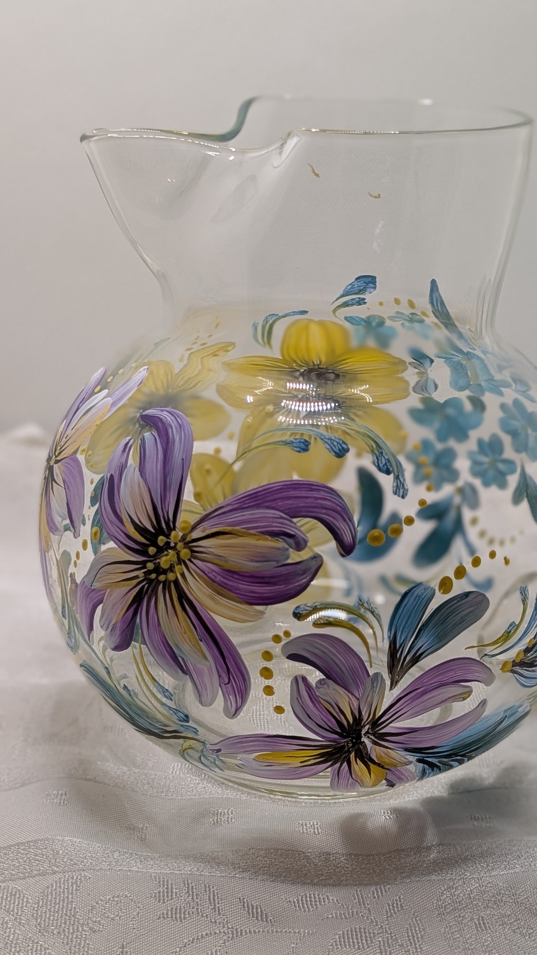 Glass pitcher with purple and yellow mixed florals
